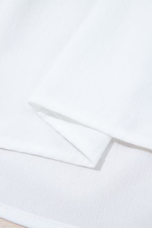 Дамска блуза в бяло със свободна кройка, флорална бродерия и връзки