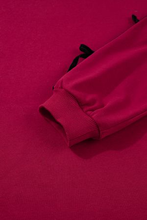 Дамска рокля в цвят бордо с джобове и ефектни панделки по ръкавите